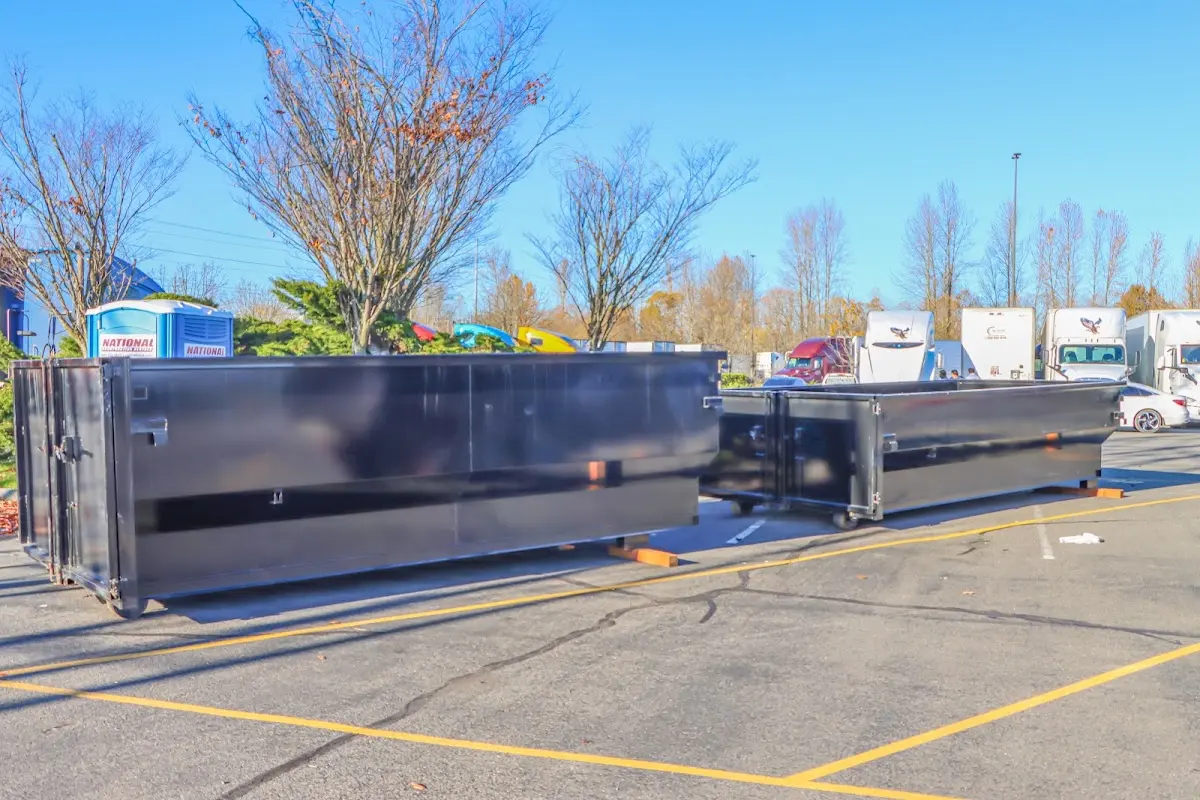 Professional dumpster rental service with roll-off container on residential driveway in Spanish Fork